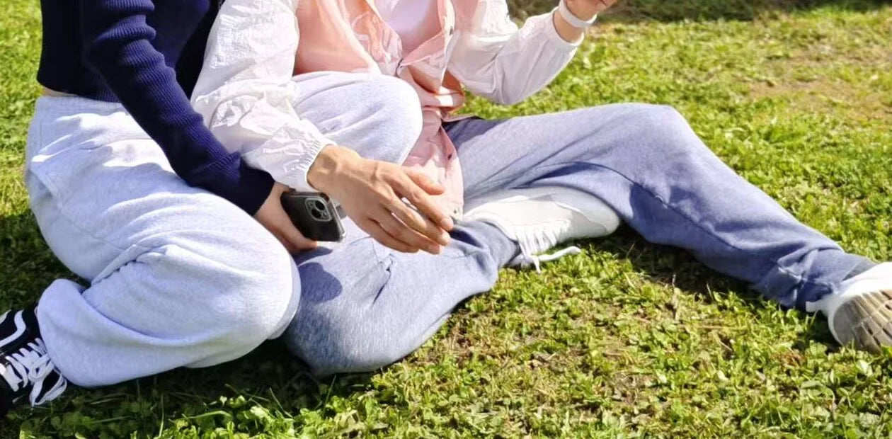 Two people wearing Footle sneakers outdoors during an ordinary weekend