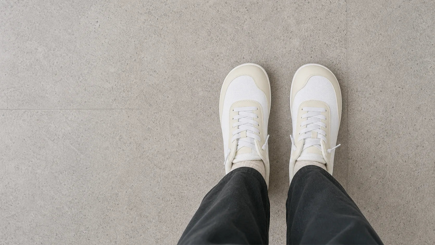 Top-down view of white Footle sneakers being worn
